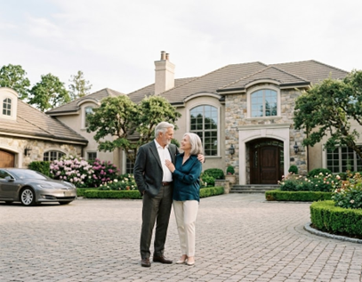 image of a couple standing in their driveway looking happy